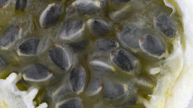 Top view from above of sweet granadilla pulp. Slowly rotating on the turntable isolated on the white background. Close-up. Macro.