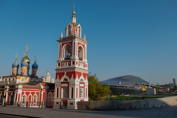 The old Church on the background of modern buildings.