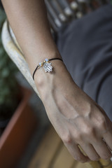 Female hand wrist resting with tiny jewelry