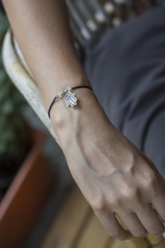 Female hand wrist resting with tiny jewelry