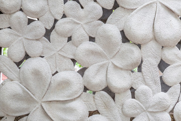 Fototapeta na wymiar White cement hibiscus flower stone