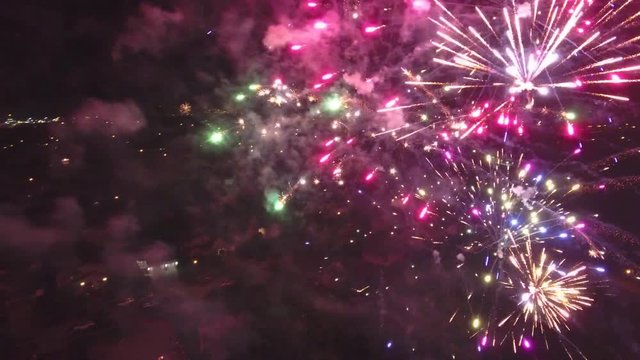 Very close aerial view firework show, slow rotation over neighborhood
