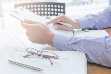 Administrator business man financial inspector and secretary making report, calculating or checking balance.