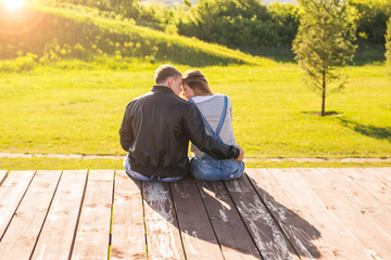 Fototapeta premium Love couple hugging in autumn nature back view