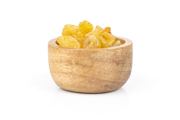 Lot of whole dry golden raisins sultana variety with wooden bowl isolated on white background