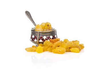 Lot of whole dry golden raisins sultana variety in small caviar bowl isolated on white background