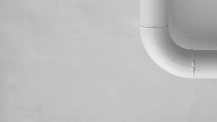 curve of white steel pipe at white cement wall.