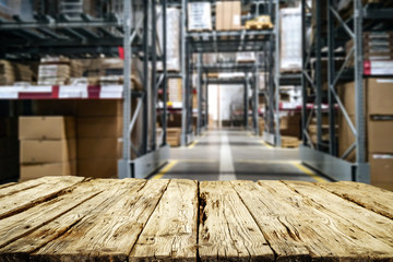 Desk of free space for your product and background of werehouse 