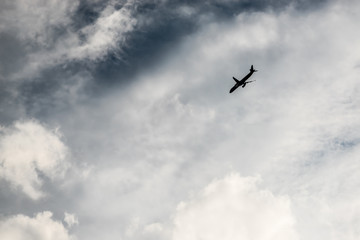 The plane flies in the clouds