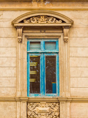 View of the window with a bas-relief on the facade of the building, Punta Arena, Chile. Vertical.