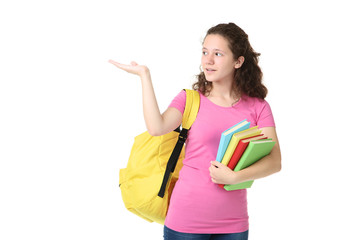 Young girl with backpack and books on white background