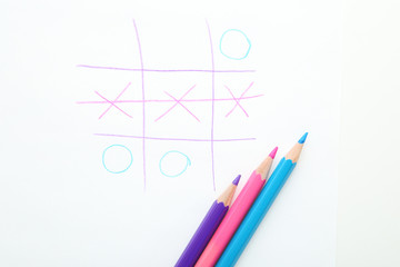 Tic tac toe game drawn by colorful pencils on white background