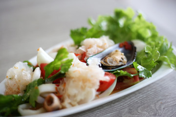 Spicy seafood salad cooked by fresh seafood ingredient such as prawn, squid, mussel mixed with vegetables.
