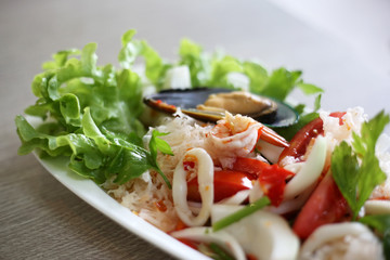 Spicy seafood salad cooked by fresh seafood ingredient such as prawn, squid, mussel mixed with vegetables.