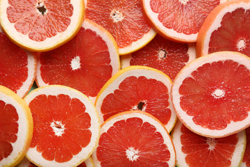 Ripe grapefruits slices background