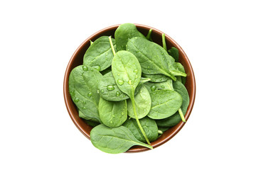 Spinach leafs in bowl isolated on white background