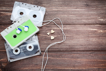 Cassette tapes with earphones on wooden table