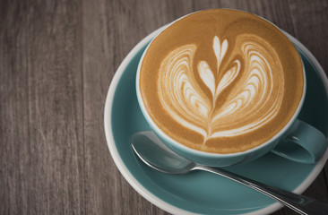 latte or Cappuccino with frothy foam, coffee cup top view on table in cafe.