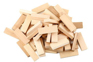 Heap of wooden blocks tower game isolated on white