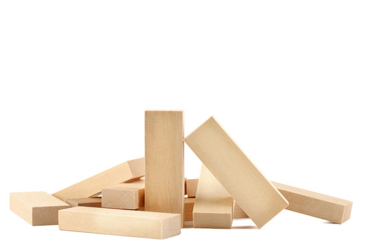 Heap of wooden blocks tower game isolated on white