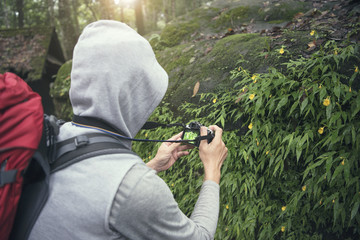 Environmental scientist photographing researching the environment and natural diversity.