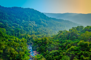 A stream flowing through green mountain range. Landscape from Maharashtra, India.