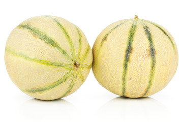 Group of two whole fresh melon cantaloupe variety isolated on white background