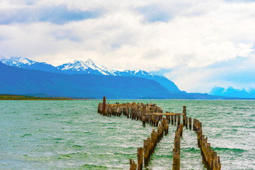 Wooden pillars of the old pier, Puerto Natales, Chile. Copy space for text.