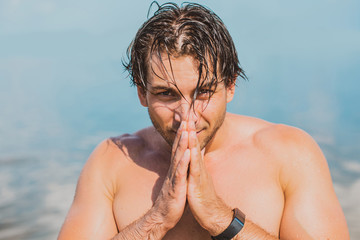Handsome man in water, sexy guy showing muscular fit body. Concept os sport life of men. Muscular...