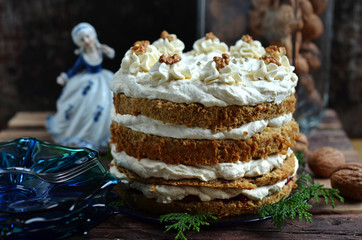 Multi-layered cake with whipped cream on a wooden background