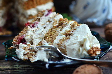 A piece of cake with caramel cream and whipped cream on a blue saucer