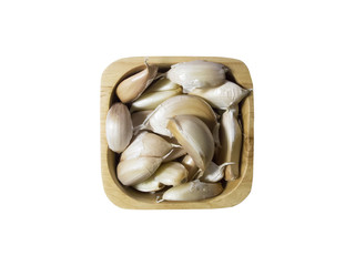 Top view Garlic in a wooden bowl on white background