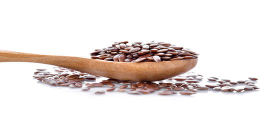Flax seeds in wood spoon on white background