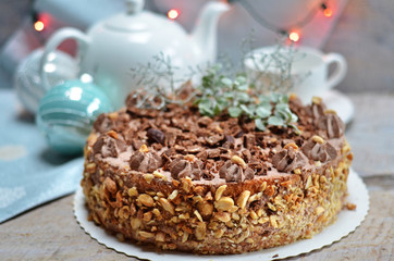 Chocolate cake with nuts on a wooden background