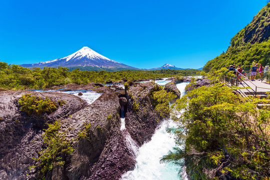 Fototapeta Salutos de Petrohue waterfalls and volcano Osorno, Puerto Varas, Chile. Copy space for text.