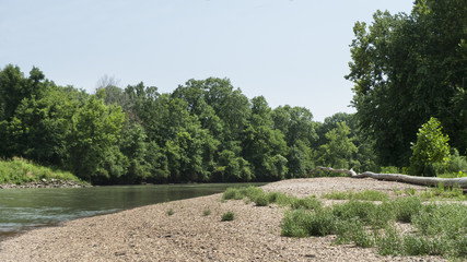 River in eastern Oklahoma with rocky shores and lush green trees