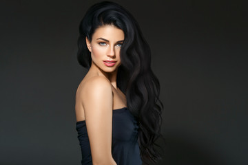 Black hair woman. Beautiful brunette hairstyle fashion portrait over dark background
