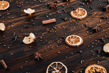 Dried fruits with spices on wooden background