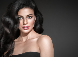 Black hair woman. Beautiful brunette hairstyle fashion portrait over dark background