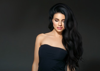 Fototapeta premium Black hair woman. Beautiful brunette hairstyle fashion portrait over dark background