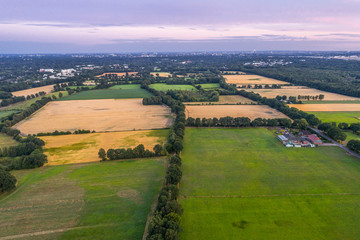 Aerial view of amazing sunset over the park in Germany. Hill and lake from birds eye view. 