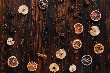 Dried fruits with spices and empty space for text on wooden background