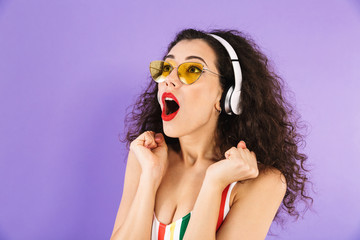 Portrait of an excited young woman dressed in swimsuit
