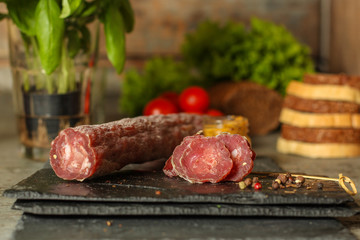 salami, salted meat jerky - sliced ​​with slices (venison) . food background.  Top view with...