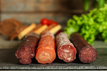 salami, salted meat jerky - sliced ​​with slices (venison) . food background.  Top view with copy space