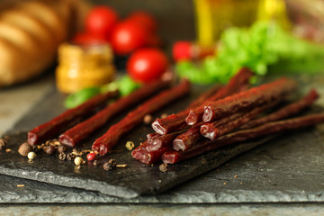 salami, salted meat jerky - sliced ​​with slices (venison) . food background.  Top view with copy space