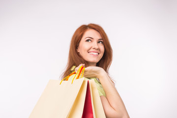 Consumer, sale and people concept - Style redhead woman holding shopping bags