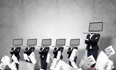 Business women with laptops instead of head.