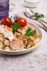 Slices of fried fish with vegetables