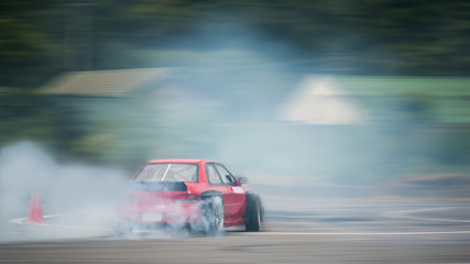 Motion blurred of driving a drift car by a skilled driver and having experience on a speed track